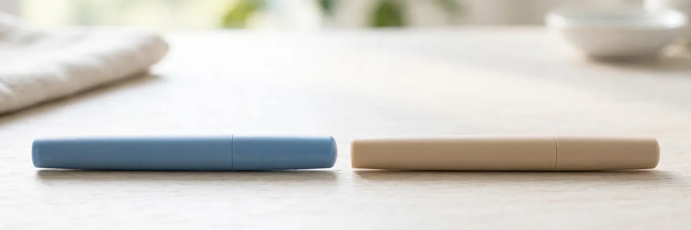 Two unbranded injection pens side by side on a bright table